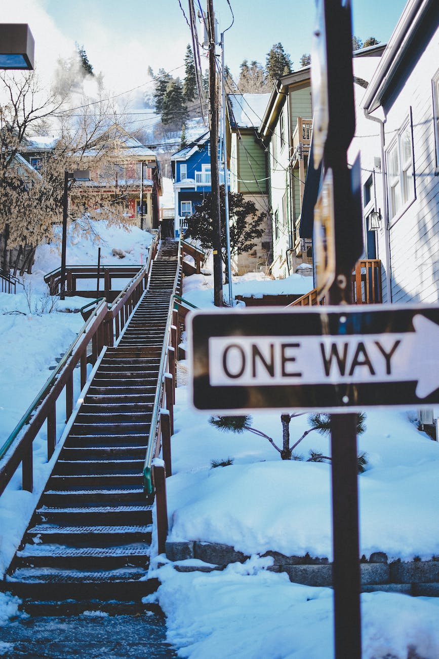 one way road sign and staircase