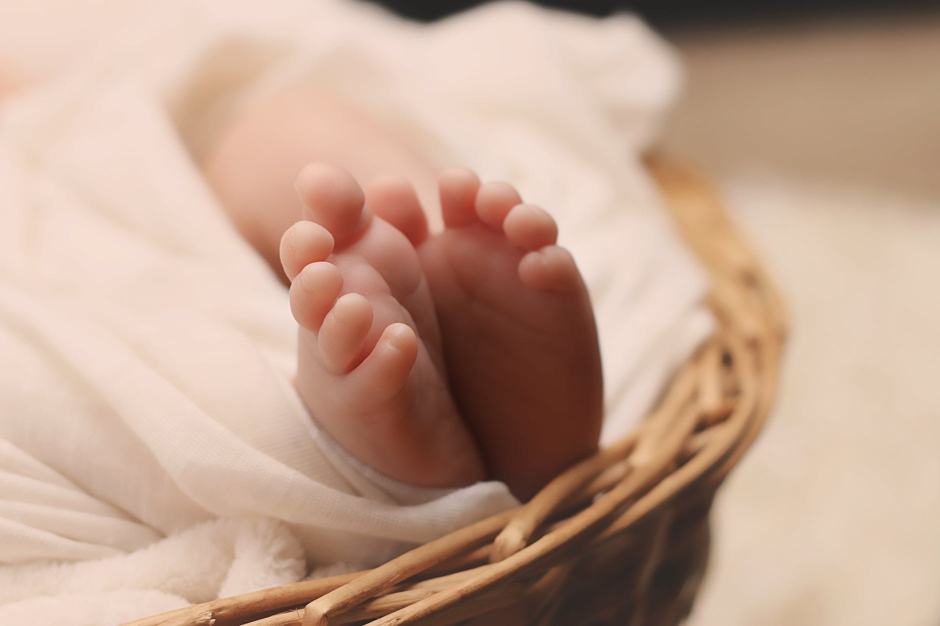 Baby feet sticking out of a basket